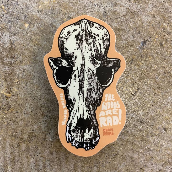 Sticker with a fox skull design and text on a textured surface