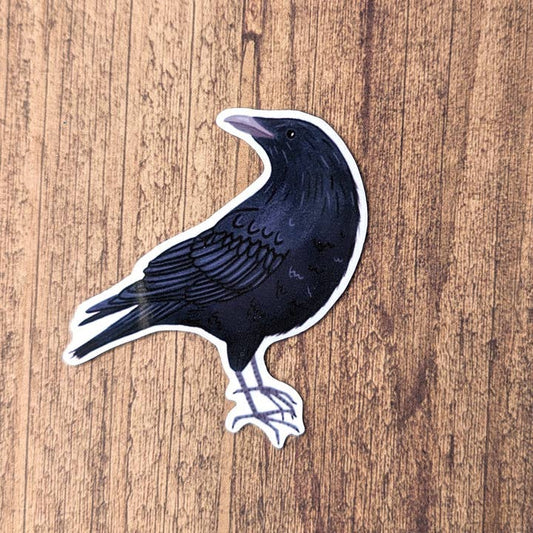 Sticker of a black bird on a wooden surface