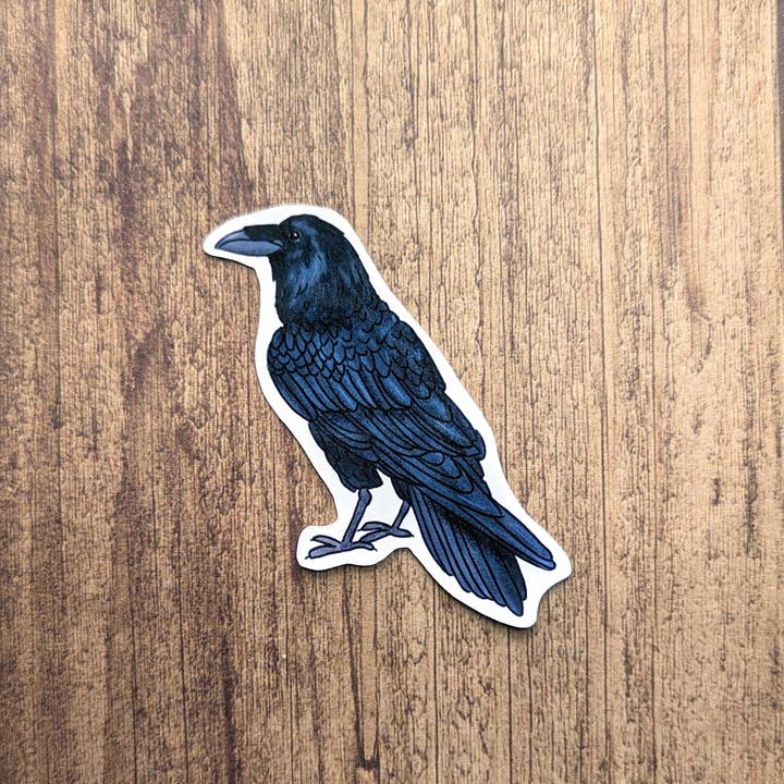 Sticker of a blue crow on a wooden surface