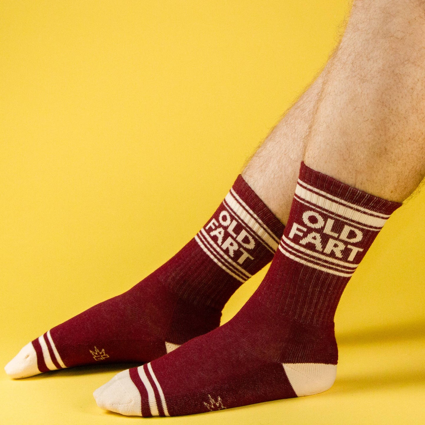 Maroon socks with 'OLD FART' text on a yellow background