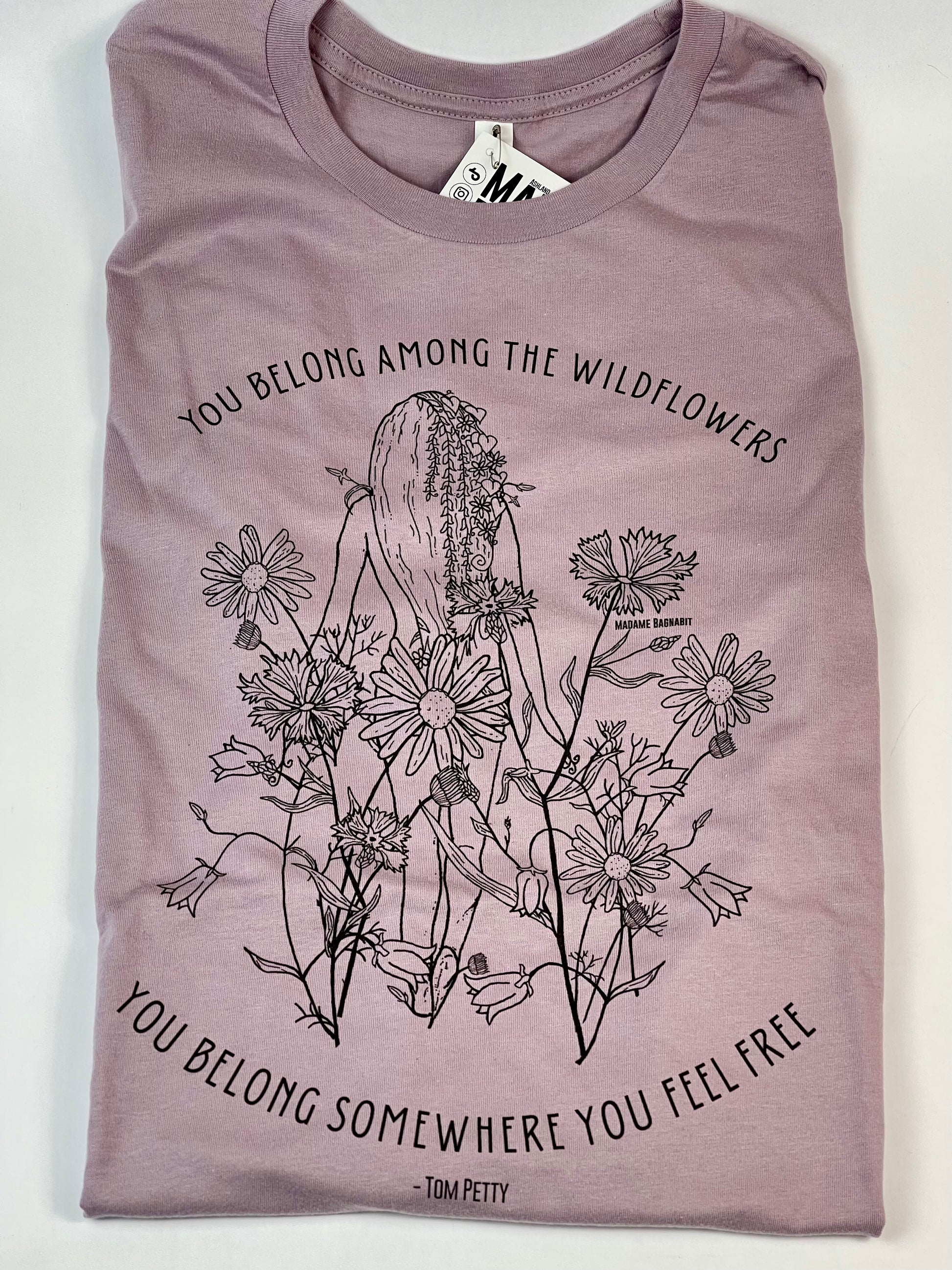 Purple t-shirt with floral design and text on a white background