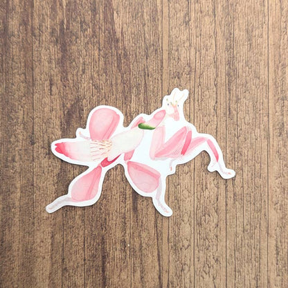 Sticker of a pink flower on a wooden surface