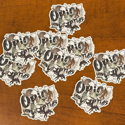 Multiple stickers with a graphic design on a wooden surface