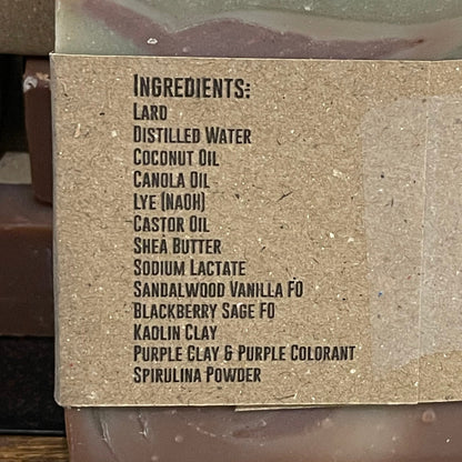 Bar of soap with visible ingredient list on a wooden surface