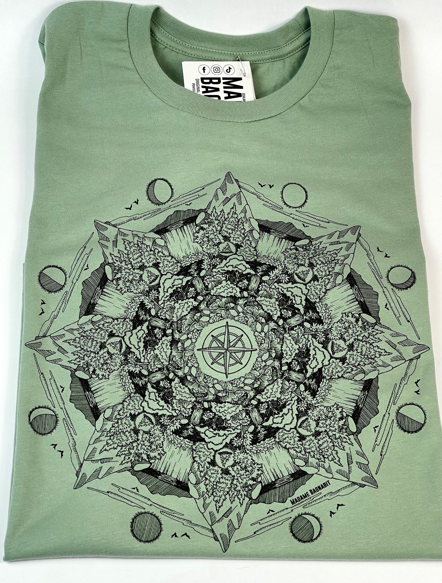 Green t-shirt with black mandala design on a white background