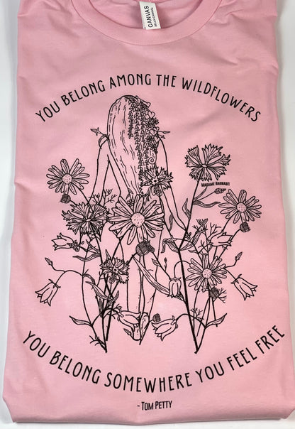 Pink t-shirt with black floral and cactus design and text on a white background