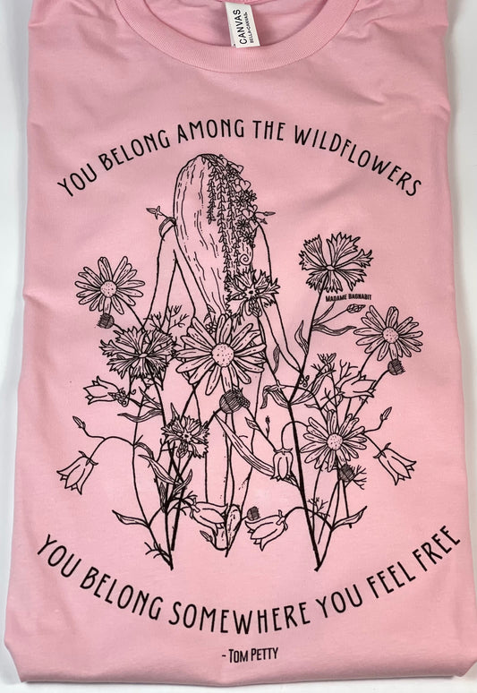 Pink t-shirt with black floral and cactus design and text on a white background