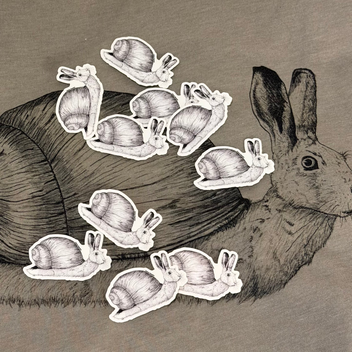 snail rabbit stickers on top of a tshirt