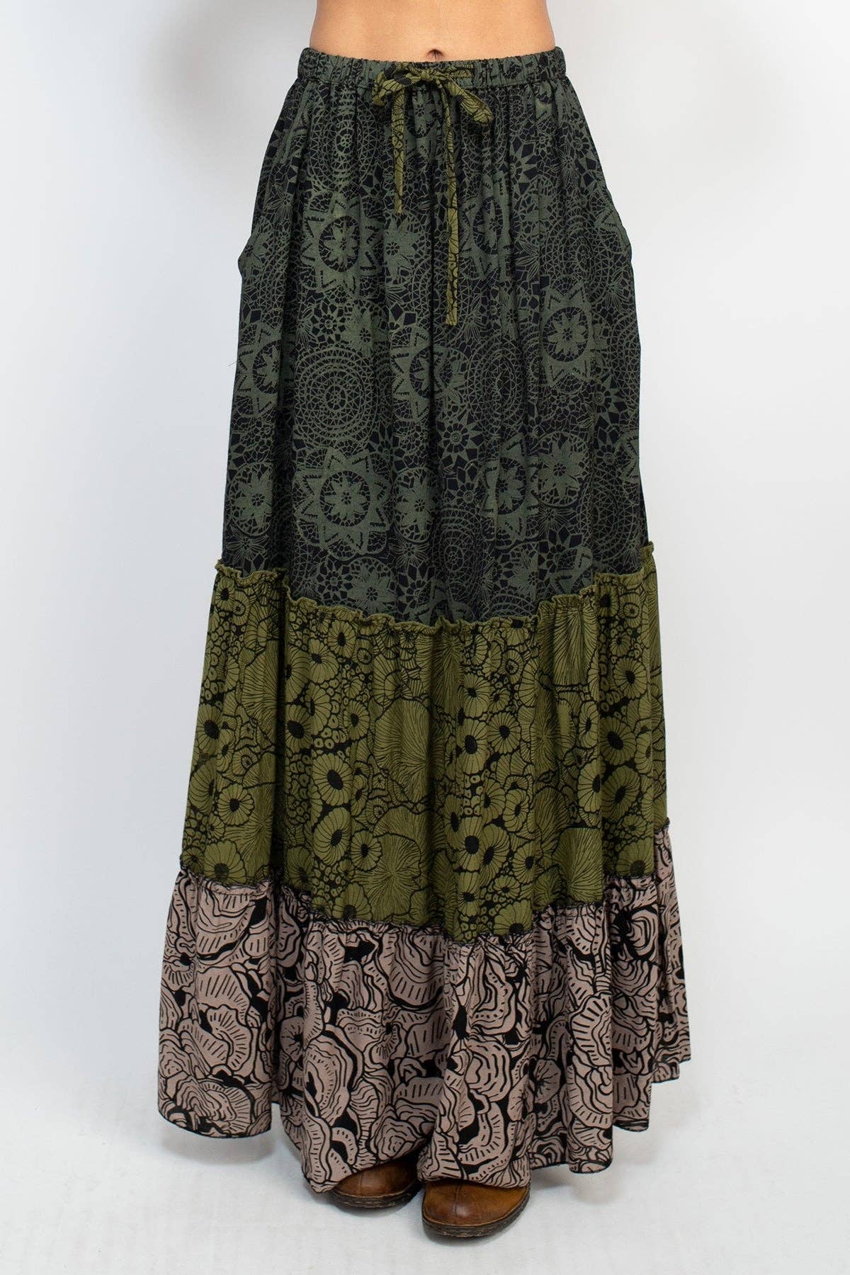 Long patterned skirt with a mix of green, brown, and black on a white background