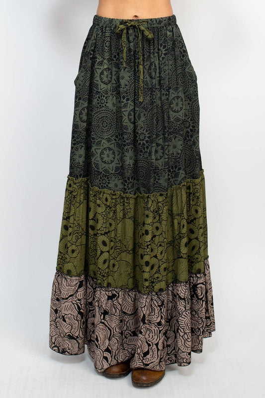 Long patterned skirt with a mix of green, brown, and black on a white background
