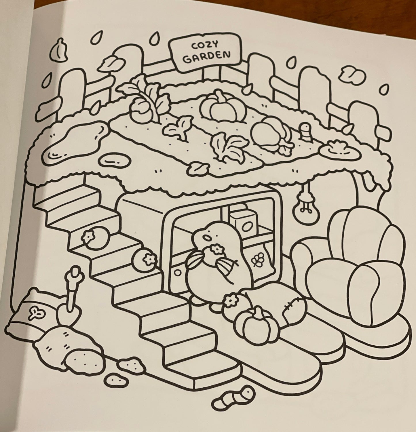Coloring book page with a garden scene to be colored